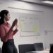 A lady presenting to board members